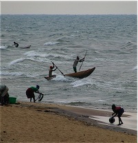 Fishermen pole into the surf of Lake Malawi